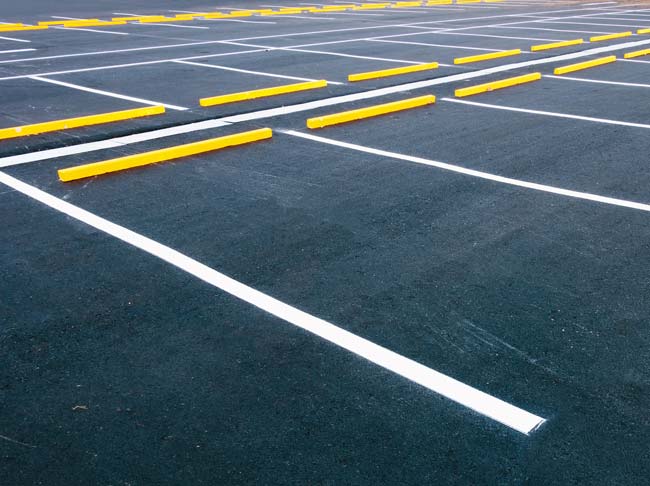 Yellow wheel stops in empty parking lot