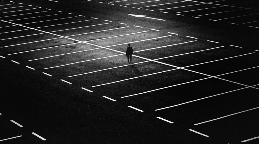 Man Standing on Parking Lot | importance of parking lot striping